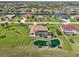 Aerial shot of a home and pool next to a pond and a canal community at 1145 Boundary Blvd, Rotonda West, FL 33947