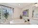 This bathroom boasts a soaking tub, decorative accents, and bright natural light at 1145 Boundary Blvd, Rotonda West, FL 33947