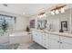 Bright bathroom featuring a soaking tub, dual vanity, and modern finishes at 1145 Boundary Blvd, Rotonda West, FL 33947