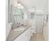 Bathroom with white vanity, large mirrors, and a shower with patterned curtain at 1145 Boundary Blvd, Rotonda West, FL 33947