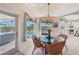Charming breakfast nook with a glass table, wicker chairs, and a view of the outdoor pool area at 1145 Boundary Blvd, Rotonda West, FL 33947