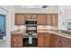 Updated kitchen featuring granite countertops, stainless appliances, and ample wood cabinetry at 1145 Boundary Blvd, Rotonda West, FL 33947
