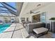 Well-appointed screened lanai and seating area overlooking the pool and manicured backyard at 1145 Boundary Blvd, Rotonda West, FL 33947