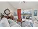 Bright living room with tile flooring, stylish furnishings, and a view of the screened-in lanai and pool at 1145 Boundary Blvd, Rotonda West, FL 33947