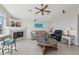 Inviting living room with fireplace, comfortable seating, and large windows providing natural light at 1145 Boundary Blvd, Rotonda West, FL 33947