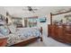 The spacious bedroom features a ceiling fan, a pool view, and is nicely decorated at 1145 Boundary Blvd, Rotonda West, FL 33947