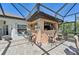 Entertain in this outdoor kitchen with bar seating, grill, and screen enclosure at 1145 Boundary Blvd, Rotonda West, FL 33947
