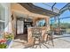 Fully-equipped outdoor kitchen featuring a refrigerator, grill, sink, and comfortable bar seating at 1145 Boundary Blvd, Rotonda West, FL 33947
