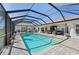 Enjoy this screened-in pool with a hot tub, brick paver deck, and ample seating area at 1145 Boundary Blvd, Rotonda West, FL 33947