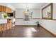 Dining area featuring hardwood floors and a large mirror, providing ample light at 12242 Chastain St, Spring Hill, FL 34609