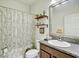 Bathroom featuring granite countertops, a shower with a patterned curtain and decorative shelving at 12857 Satin Lily Dr, Riverview, FL 33579