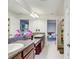 Granite counters and double sinks in bathroom, leading to bright bedroom with playful decor at 12857 Satin Lily Dr, Riverview, FL 33579