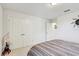 Bedroom featuring striped comforter and spacious closet, ready for comfort and storage at 12857 Satin Lily Dr, Riverview, FL 33579