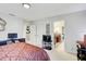 Bedroom with comfortable bed, entertainment center, and glimpse into the adjacent bathroom at 12857 Satin Lily Dr, Riverview, FL 33579