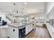 Open-concept kitchen featuring a large island, stainless steel appliances, and hardwood floors at 12857 Satin Lily Dr, Riverview, FL 33579