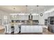 Elegant kitchen with a large island, stainless steel appliances, granite counters, and custom cabinetry at 12857 Satin Lily Dr, Riverview, FL 33579