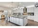 Modern kitchen featuring white cabinetry, granite countertops, stainless steel appliances, and a large island at 12857 Satin Lily Dr, Riverview, FL 33579