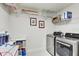 Well-equipped laundry room with stainless steel washer/dryer and shelving at 12857 Satin Lily Dr, Riverview, FL 33579