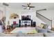 Comfortable living room features ceiling fan, hardwood floors, a TV and a gray sofa at 12857 Satin Lily Dr, Riverview, FL 33579