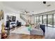 Open-concept living room with hardwood floors and sliding glass doors to the outdoor living area at 12857 Satin Lily Dr, Riverview, FL 33579