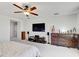 Main bedroom with ceiling fan, TV, and dresser storage at 12857 Satin Lily Dr, Riverview, FL 33579