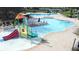 Aerial view of community pool with splash pad, zero entry, and covered lounge area at 12857 Satin Lily Dr, Riverview, FL 33579