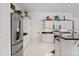 Well-lit kitchen featuring stainless steel appliances, white cabinets, and black countertops at 13166 73Rd Ave, Seminole, FL 33776