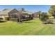 Spacious backyard featuring lush green grass, patio and screened-in enclosure at 13247 Palmilla Cir, Dade City, FL 33525