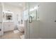 Modern bathroom showcasing a glass-enclosed shower and a soaking tub with white finishes and ample lighting at 13247 Palmilla Cir, Dade City, FL 33525
