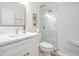 Bright bathroom featuring white subway tile in the glass-enclosed shower, and a modern vanity with a light countertop at 13247 Palmilla Cir, Dade City, FL 33525