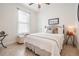 Inviting bedroom with a large window, patterned rug, comfortable bed, and stylish decorations at 13247 Palmilla Cir, Dade City, FL 33525