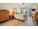 Comfortable bedroom with a ceiling fan, sliding glass doors, and natural wood furniture at 13247 Palmilla Cir, Dade City, FL 33525