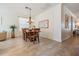 Well-lit dining room featuring a chandelier, large table with seating for six, and a wall of art at 13247 Palmilla Cir, Dade City, FL 33525