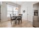 Cozy dining area featuring tile flooring, a modern chandelier, and a round table set for four at 13247 Palmilla Cir, Dade City, FL 33525