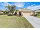 Charming single-story home featuring a well-manicured lawn and an attached two-car garage at 13247 Palmilla Cir, Dade City, FL 33525
