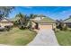 Well maintained home with a green tile roof, attached garage, and a beautifully landscaped front yard at 13247 Palmilla Cir, Dade City, FL 33525