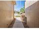 View of the front yard and driveway, framed by textured walls with a glimpse of the garage at 13247 Palmilla Cir, Dade City, FL 33525