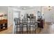 Open kitchen features bar seating, modern appliances, granite countertops, and ample space at 13247 Palmilla Cir, Dade City, FL 33525