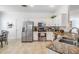 Well-lit kitchen featuring stainless steel appliances, granite countertops, white cabinets, and tile flooring at 13247 Palmilla Cir, Dade City, FL 33525