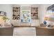 Bright living room with custom built-in shelving, window seat and natural light at 13247 Palmilla Cir, Dade City, FL 33525