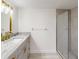 Modern bathroom vanity with granite counters, gold accents, and walk-in shower at 1375 Doolittle Ln # 103, Dunedin, FL 34698