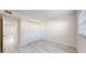 Spare bedroom with wood floors, closet, and bright window with natural light at 1375 Doolittle Ln # 103, Dunedin, FL 34698