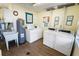 Well-maintained laundry room with newer washer and dryer, utility sink, and ample space at 1375 Doolittle Ln # 103, Dunedin, FL 34698