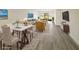 Bright living room featuring wood floors, modern furniture, and access to the outside patio at 1375 Doolittle Ln # 103, Dunedin, FL 34698