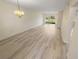 A neutral living room with tile flooring, modern lighting, and sliding glass door access to the outdoors at 1375 Doolittle Ln # 103, Dunedin, FL 34698