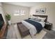 Comfortable main bedroom with modern décor and light gray wood-look flooring at 1375 Doolittle Ln # 103, Dunedin, FL 34698