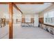 Open living room with exposed studs, wood beams, and white-washed flooring showcasing the home's renovation potential at 14031 E Parsley Dr, Madeira Beach, FL 33708