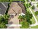 Aerial view of home featuring well-manicured lawn, tropical landscaping, and brick-paved driveway at 14315 Rolling Dune Rd, Lithia, FL 33547