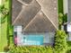 Aerial view of home featuring screened-in pool, spa, and well-maintained landscaping at 14315 Rolling Dune Rd, Lithia, FL 33547