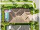 Aerial view of home with screened-in pool, brick-paved driveway, and lush landscaping at 14315 Rolling Dune Rd, Lithia, FL 33547